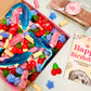 Birthday pick and mix box open to show the sweets you get inside, with a bar of salted caramel fudge and a happy birthday marketing card- Rupert's Candy