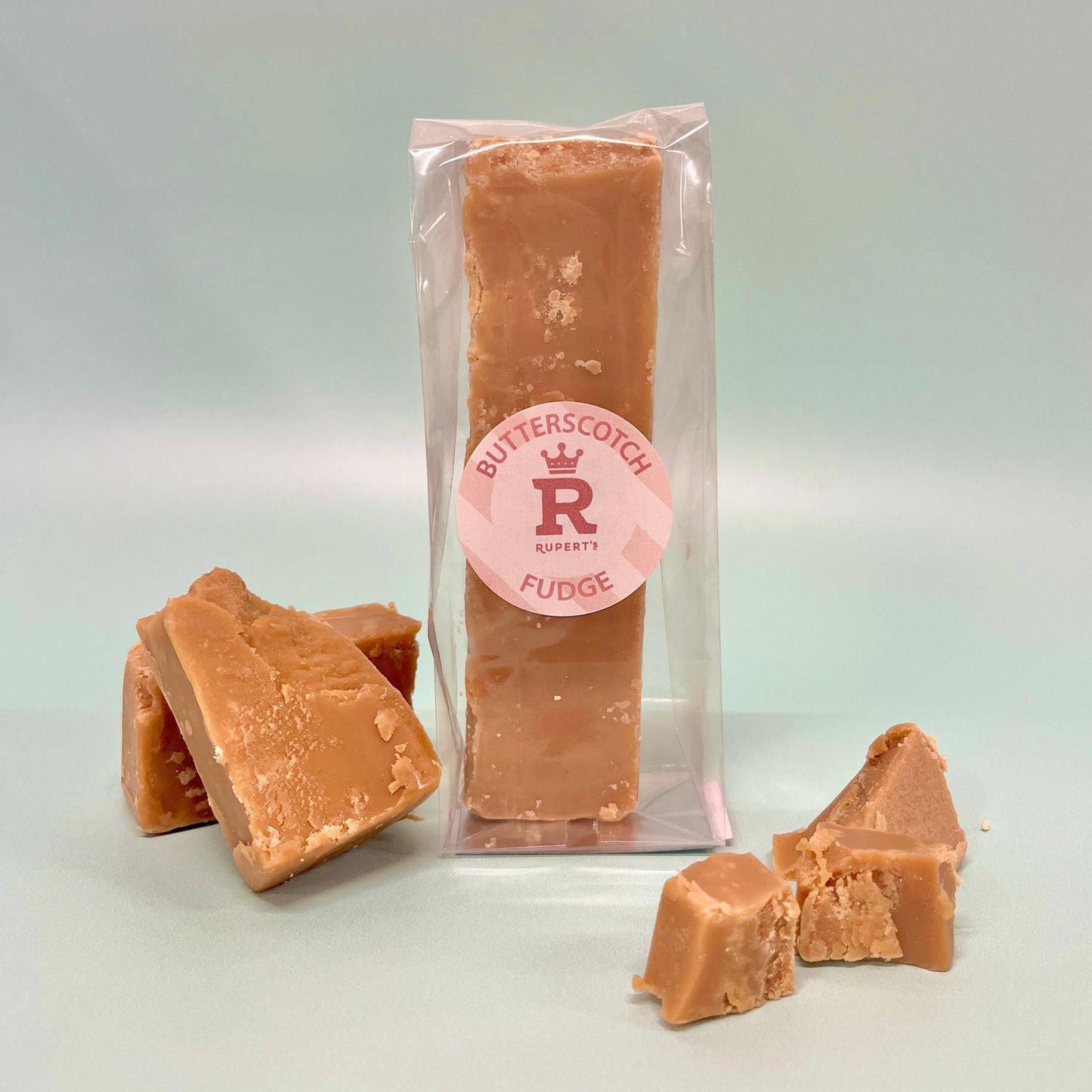 Bar of our butterscotch fudge finger with pieces of fudge placed in front of it- Rupert's Candy