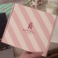 Real life photo or Rupert's candys pink box being held- Rupert's Candy