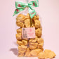 Large gift bag of our naked honeycomb cinder toffee with pieces of honeycomb placed in front of the bag- Rupert's Candy