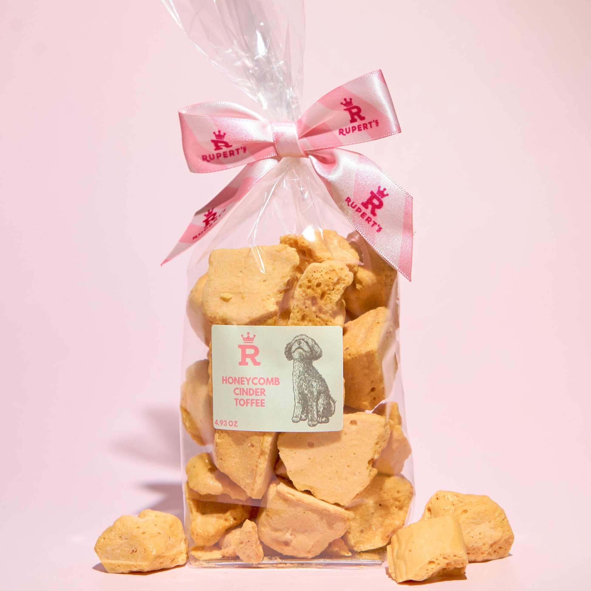 Small gift bag of our naked honeycomb cinder toffee with pieces of honeycomb placed in front of the bag- Rupert's Candy