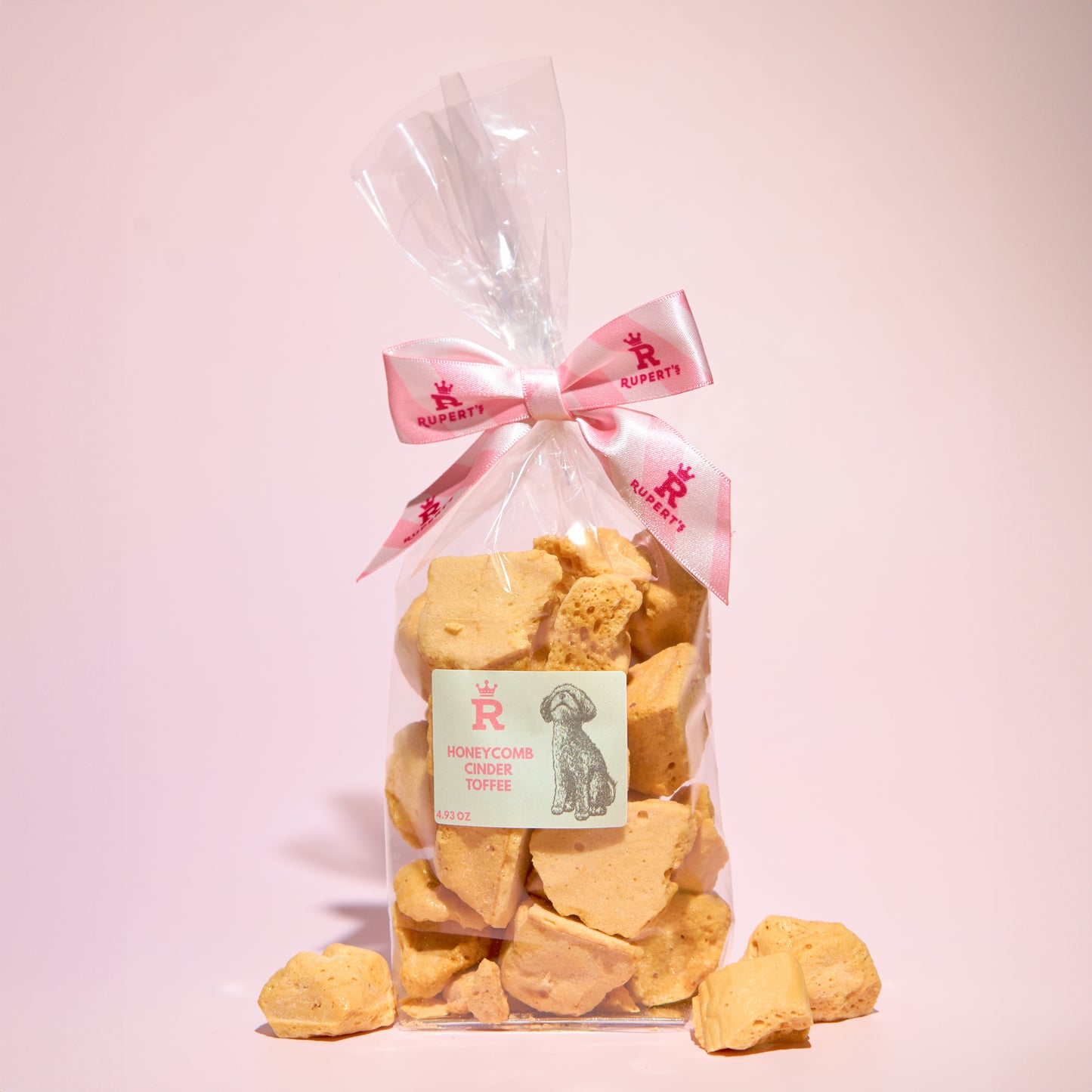 Small gift bag of our naked honeycomb cinder toffee with pieces of honeycomb placed in front of the bag- Rupert's Candy