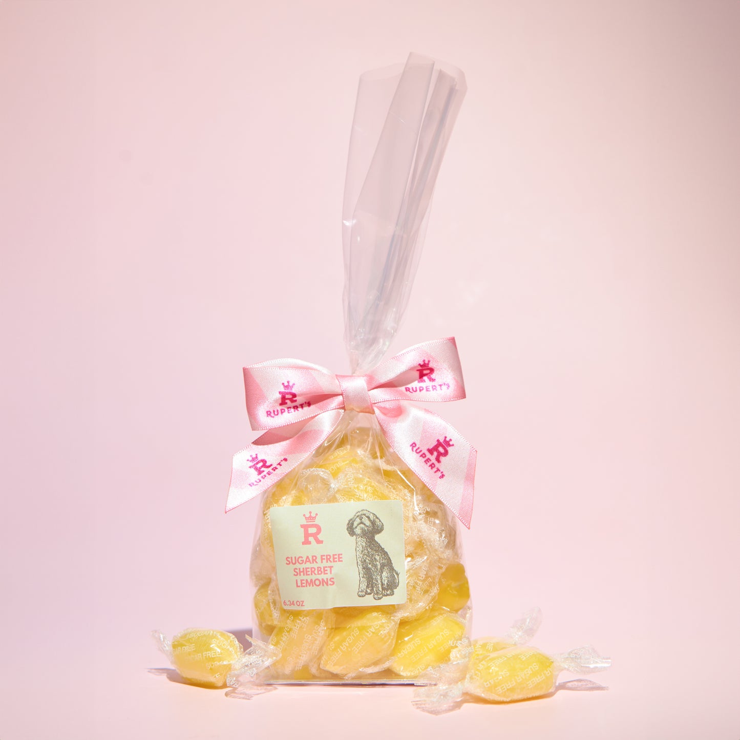 Small gift bag of sugar free sherbet lemons with some sherbet lemons place in front of the bag- Rupert's Candy