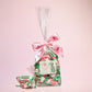 Small gift bag of spearmint chews with some spearmint chews laid next to the bag- Rupert's Candy