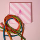 Birds Eye view of our pink Rupert's candy box and different flavours of our cables- Rupert's Candy