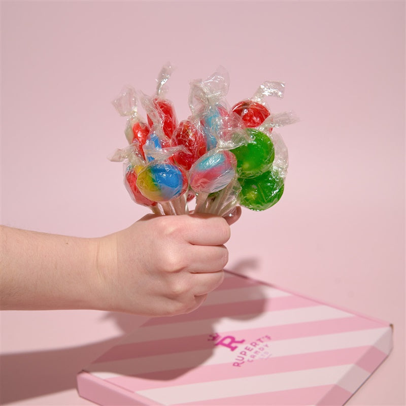 Image of hand holding a bunch of our different lollipops- Rupert's Candy